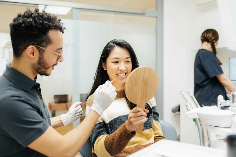 Patient and dentist viewing veneers after placement.